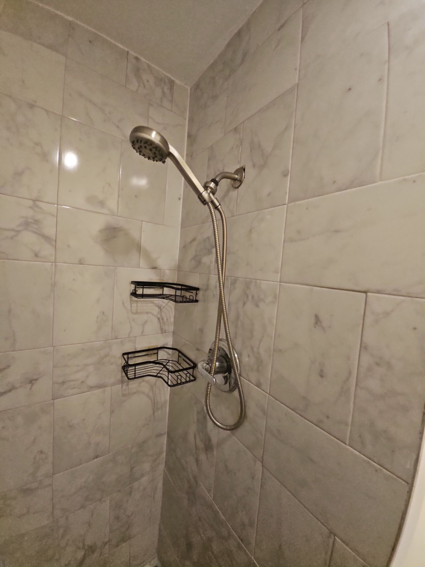 Residence C: Tiled shower and handheld showerhead